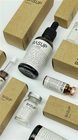 Basup essence and serum bottles, each labeled with its individual skin-type code